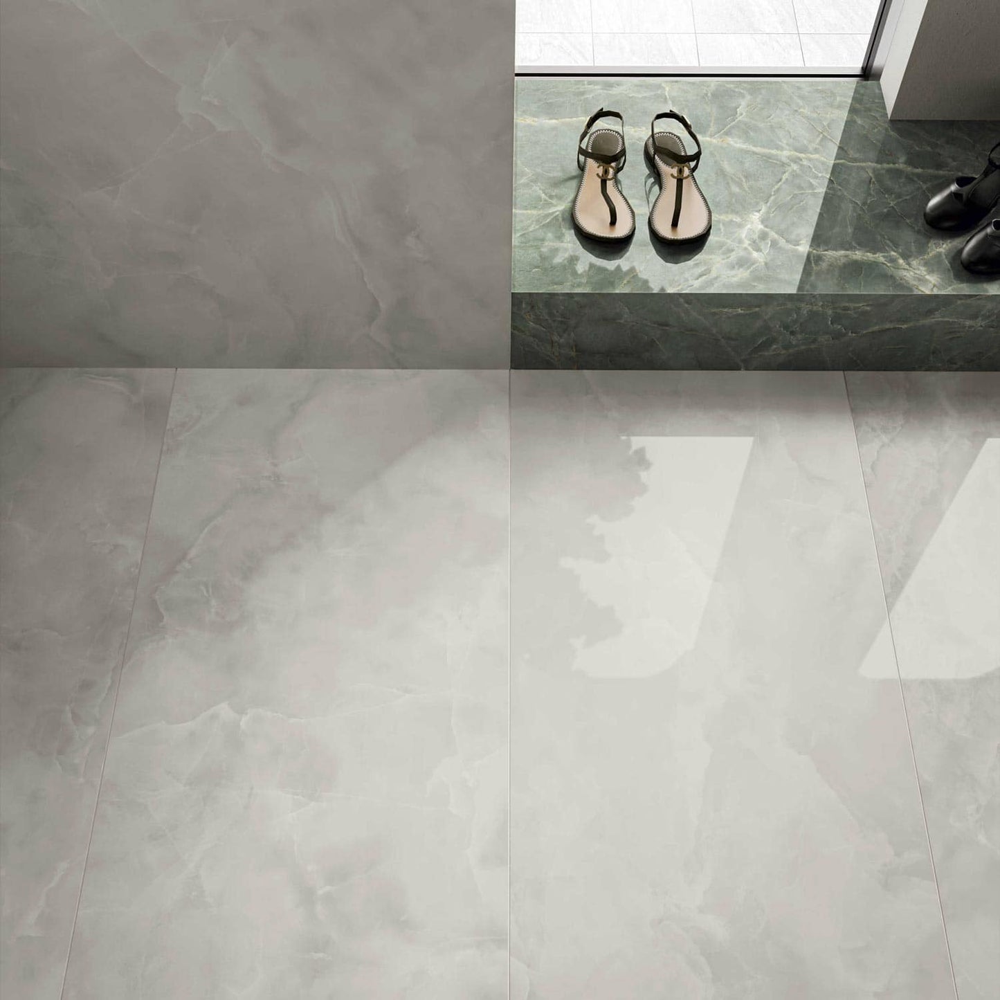 Onice Grigio polished porcelain tile with a grey onyx design, for floors and walls. Installed in a room.