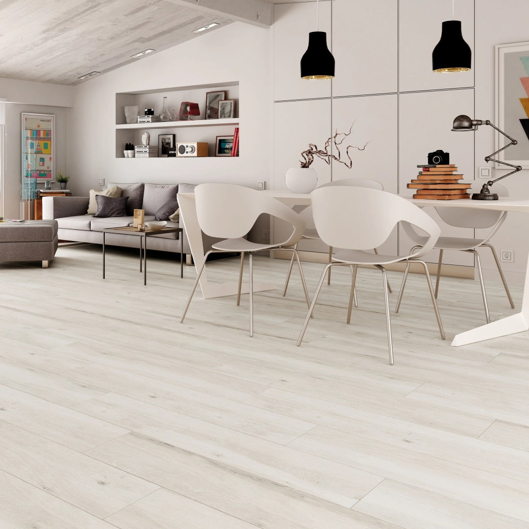 Pecan Blanco matte porcelain tile with a white wood design, for floors and walls. Made in Spain, installed in a room.