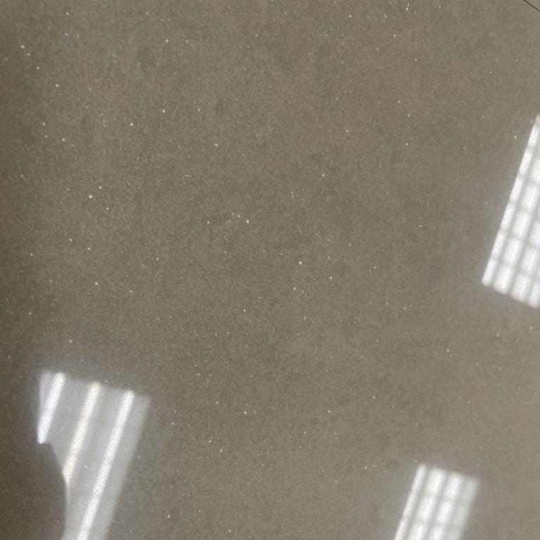 Pulpis polished porcelain tile with a solid grey/brown design, for floors and walls. In a 12x12" size.