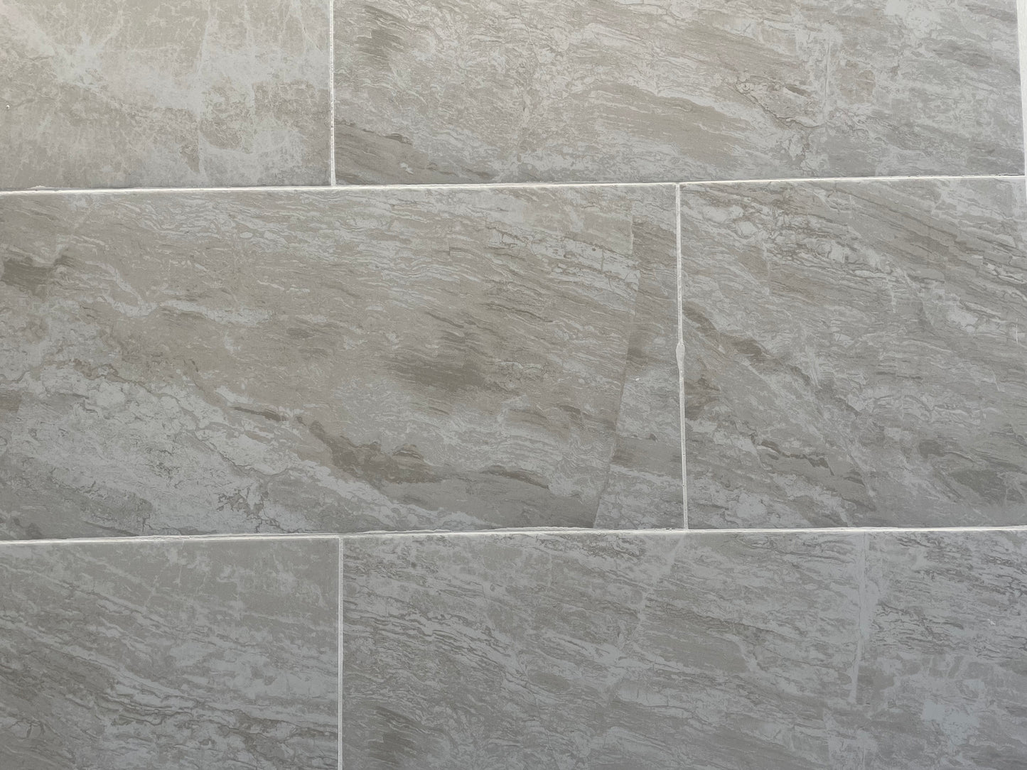 Resarva Pampa matte porcelain tile with a grey stone design, for floors and walls. In a 12x24" size.