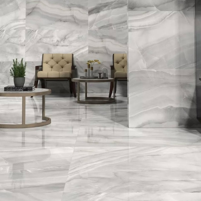 Rodas Perla polished porcelain tile with a grey onyx design, for floors and walls. Made in Spain, installed in a room.