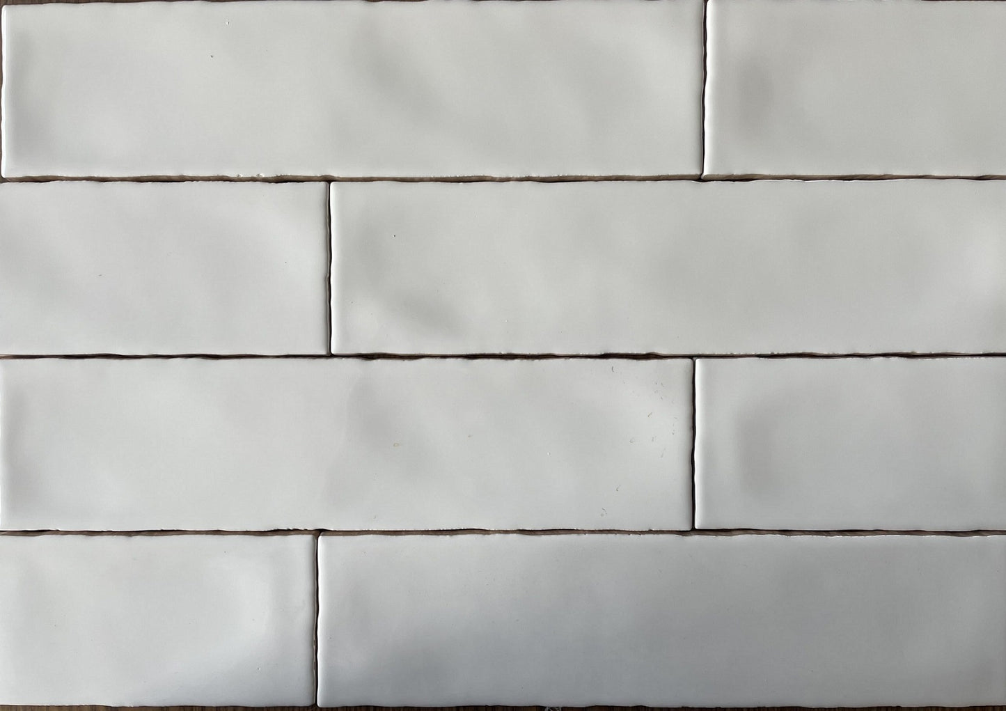 Rural Blanco white artisan style glossy ceramic subway tile with non-flat edges and surface, for walls. In a 3x12" size.