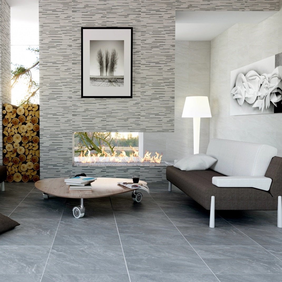 Safari Gris matte porcelain tile with a grey stone design, for floors and walls. Made in Spain, installed in a room.