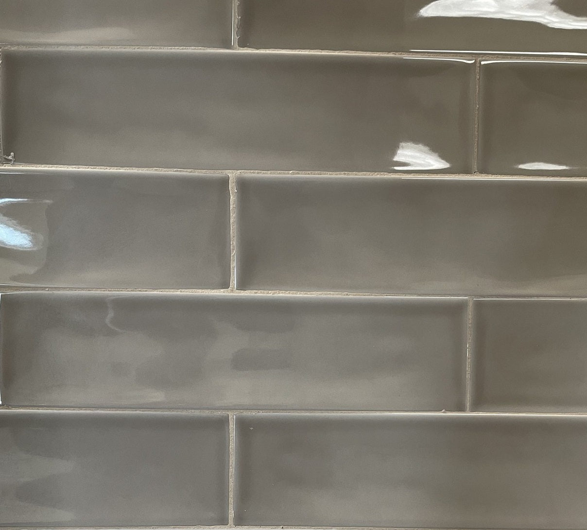 Selkis Tobacco glossy ceramic subway tile with a brown/grey solid colour, for walls. Made in Spain, in a 3x12" size.