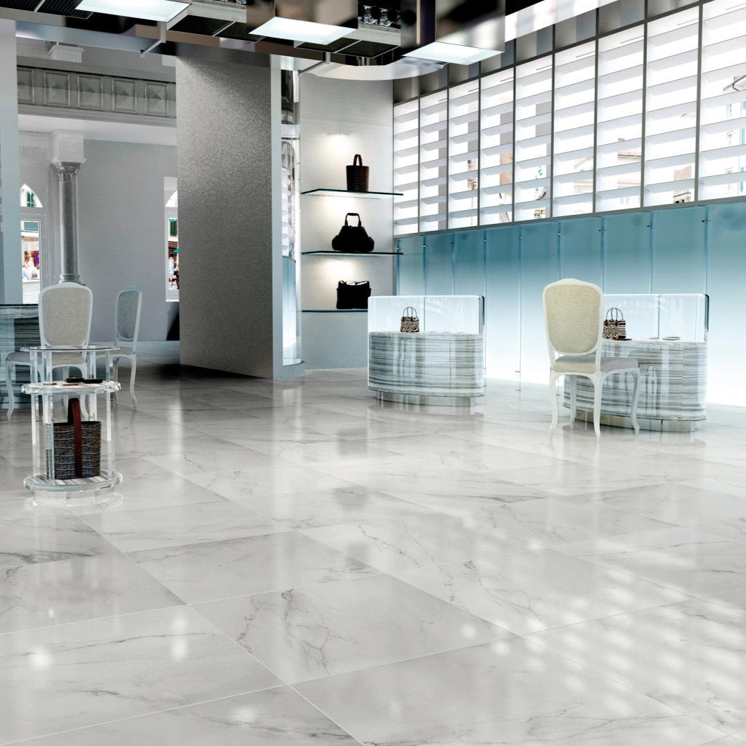 Snow polished porcelain tile with a white marble design, for floors and walls. Made in Spain, installed in a room.