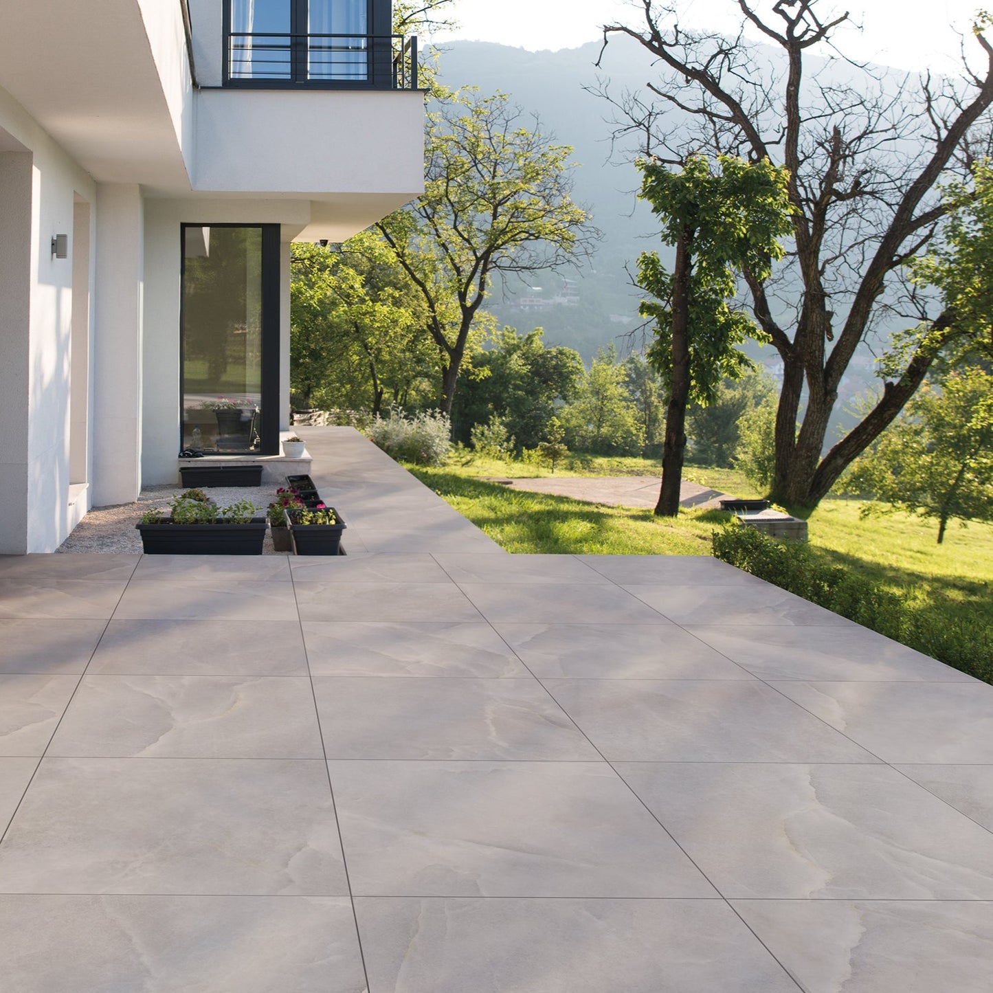 Spark White matte porcelain tile with a stone design, for floors and walls. Made in Italy, installed in a room.