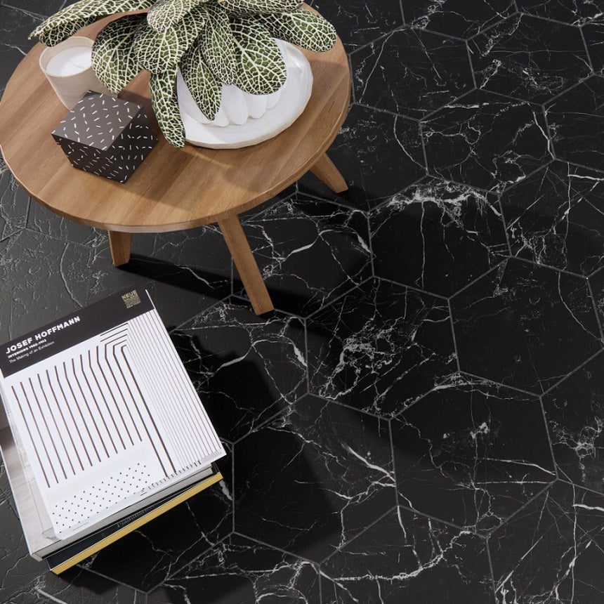 Marquina Black hexagon matte porcelain tile for floors and walls. Made in Spain, installed in a room.