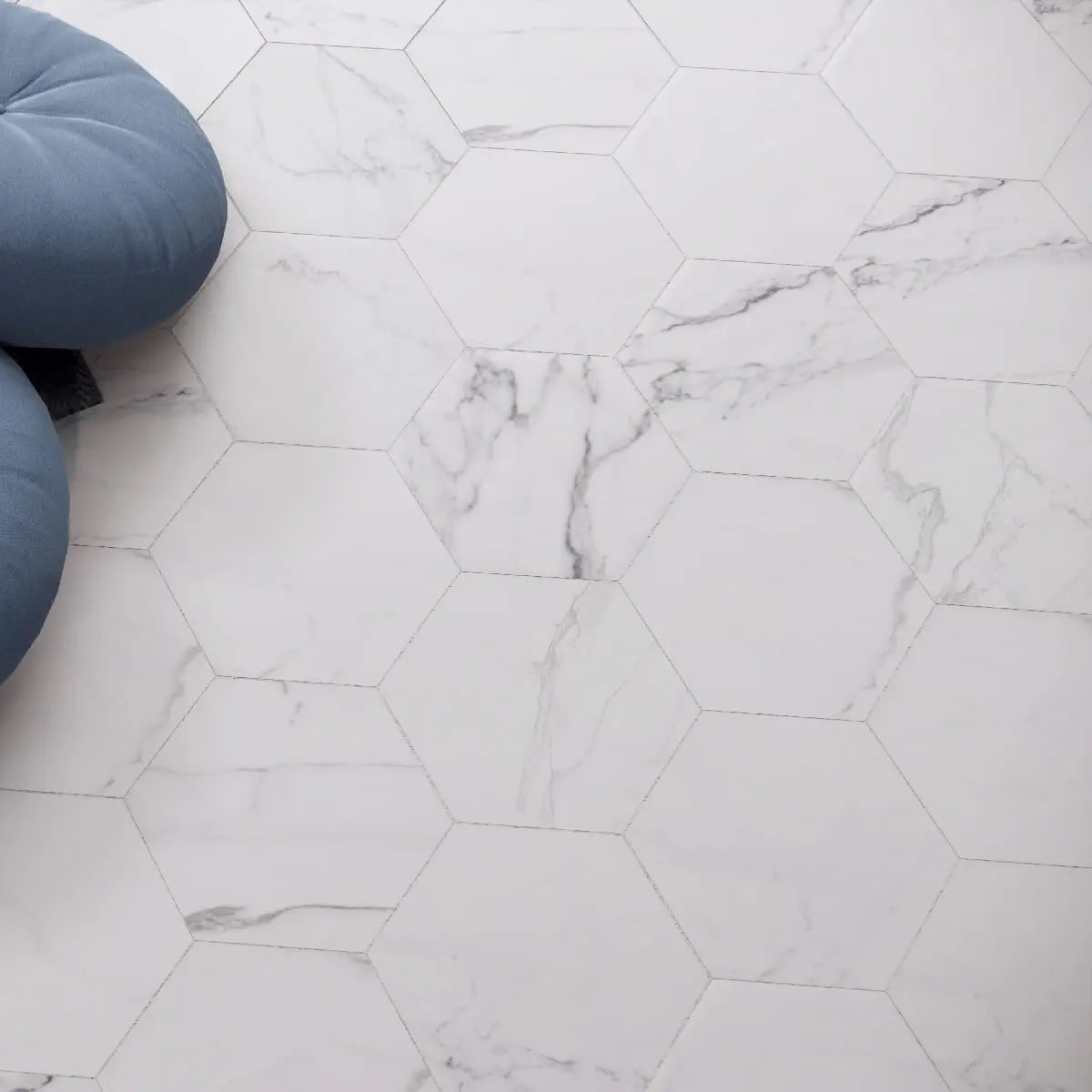 Statuarietto White hexagon matte porcelain tile for floors and walls. Made in Spain, installed in a room.