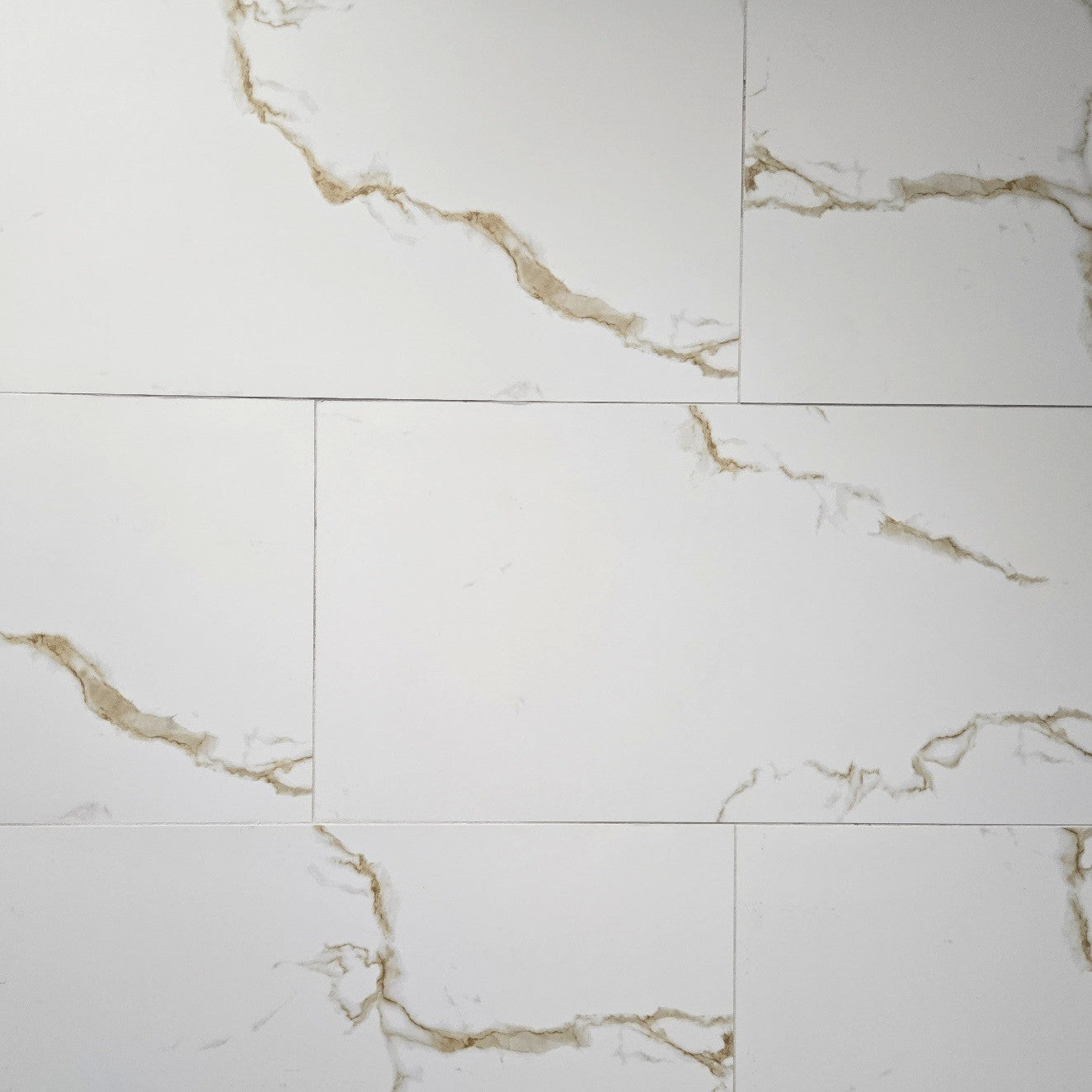 Statuario Golden matte porcelain tile with a white and gold marble design, for floors and walls. In a 12x24" size.