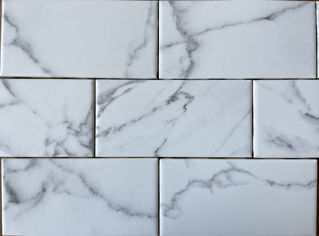 Statuary white marble style ceramic subway tile in a glossy and matte finish, for walls. In a 3x6" size.