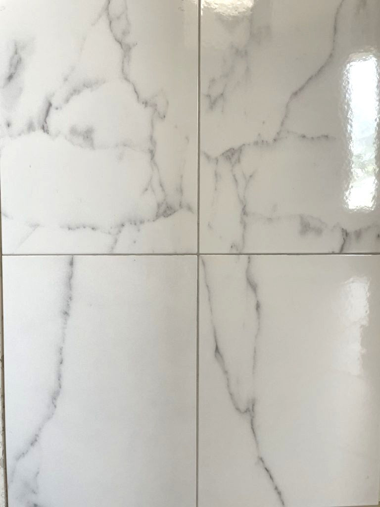 Statuary Bright glossy finish ceramic white marble style wall tile. In a 10x13" size.