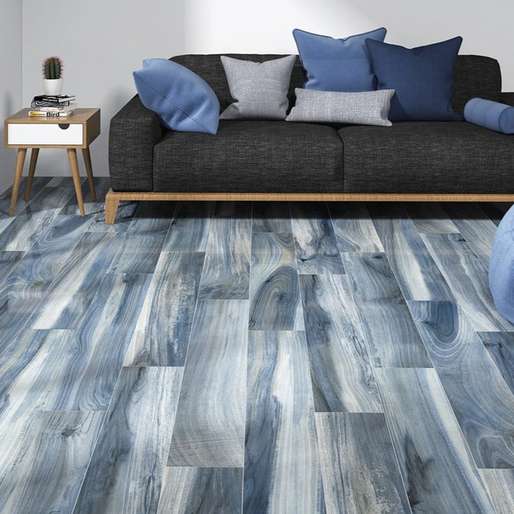 Tasmania Rain polished porcelain tile with a blue wood design, for floors and walls. Made in Spain, installed in a room.