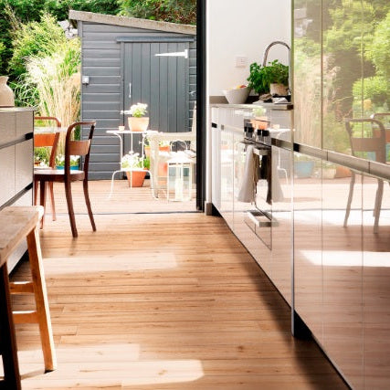 Travekheart Beige matte porcelain tile with a wood design, for floors and walls. Made in Italy, installed in a room.