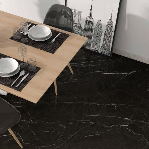 Valentina polished porcelain tile with a black and white marble design, for floors and walls. Installed in a room.