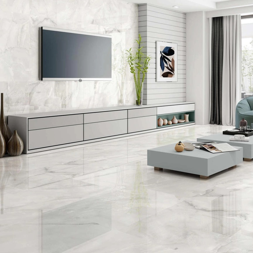 Venus White porcelain tile with a white onyx design, for floors and walls. Made in Spain, installed in a room.