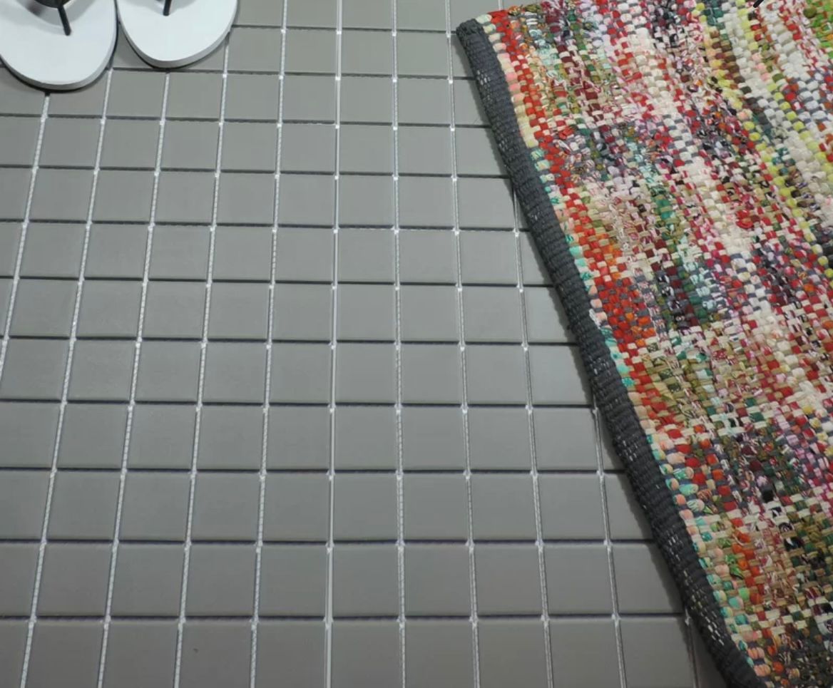 Vintage Shadow pure dark grey square porcelain mosaic, for floors and walls. Installed on a floor.