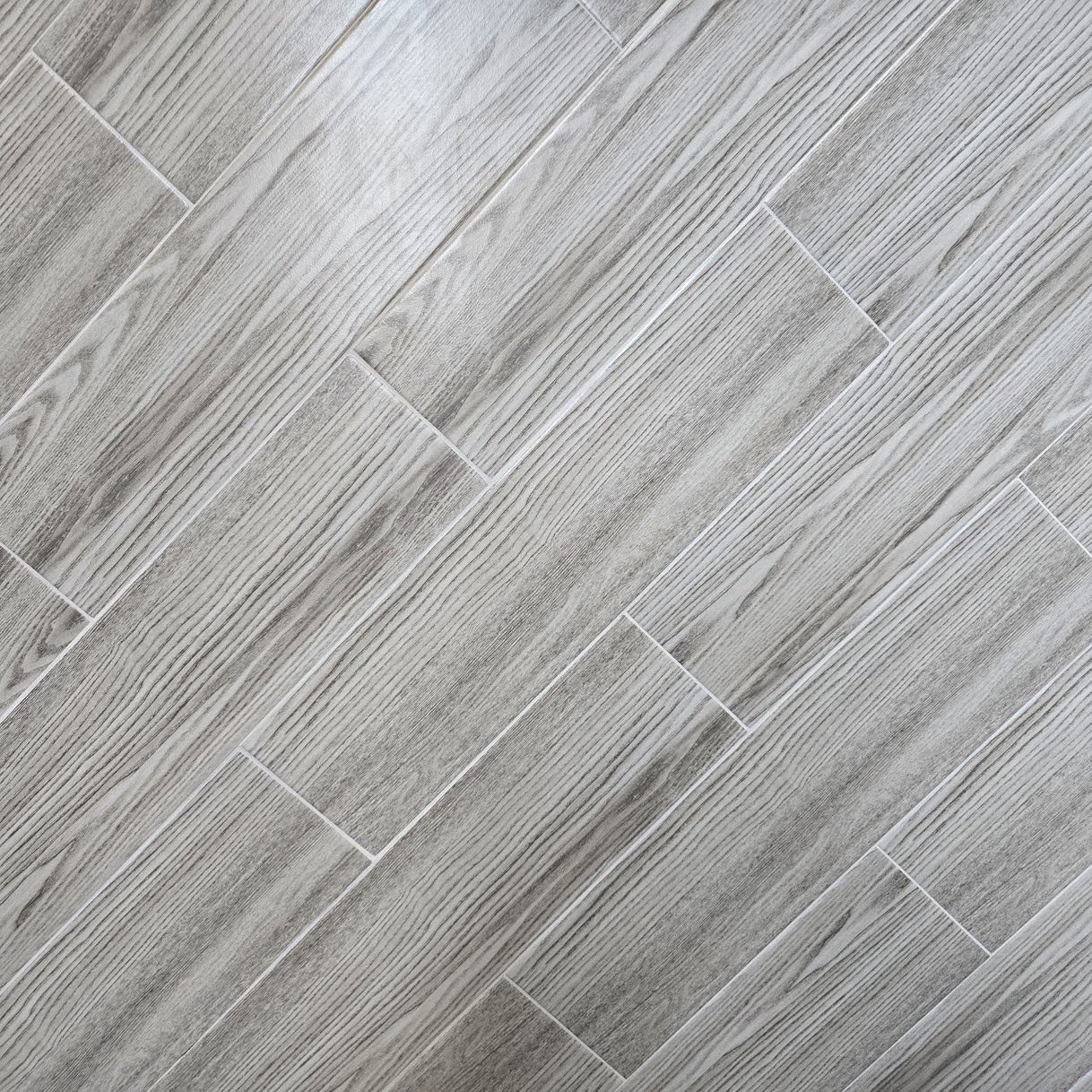 Winter Cabin matte ceramic tile with a light grey wood design, for floors and walls. In a 6x24" size.