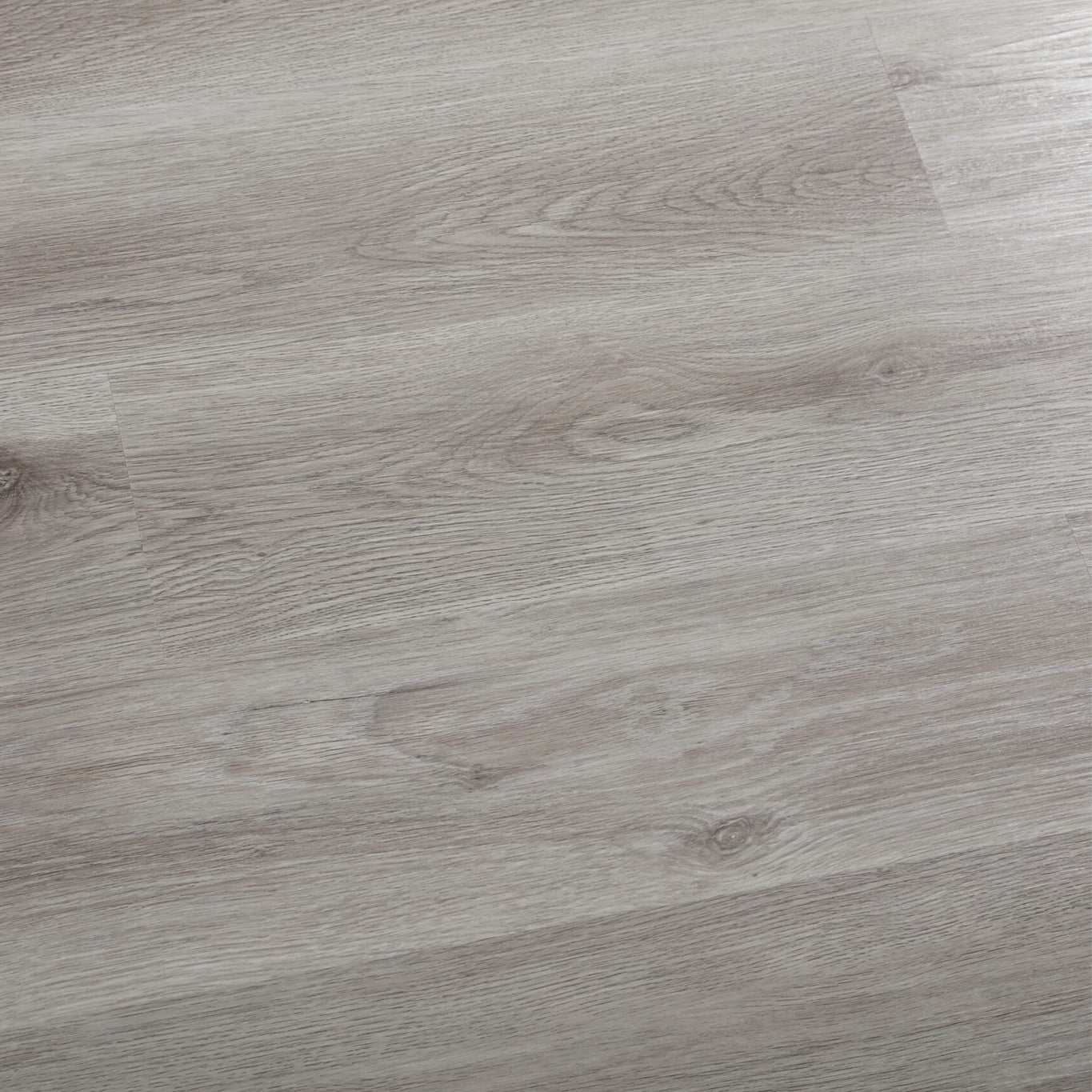 SPC Vinyl flooring in a natural grey wood look in a 7x48" size, installed on a floor.