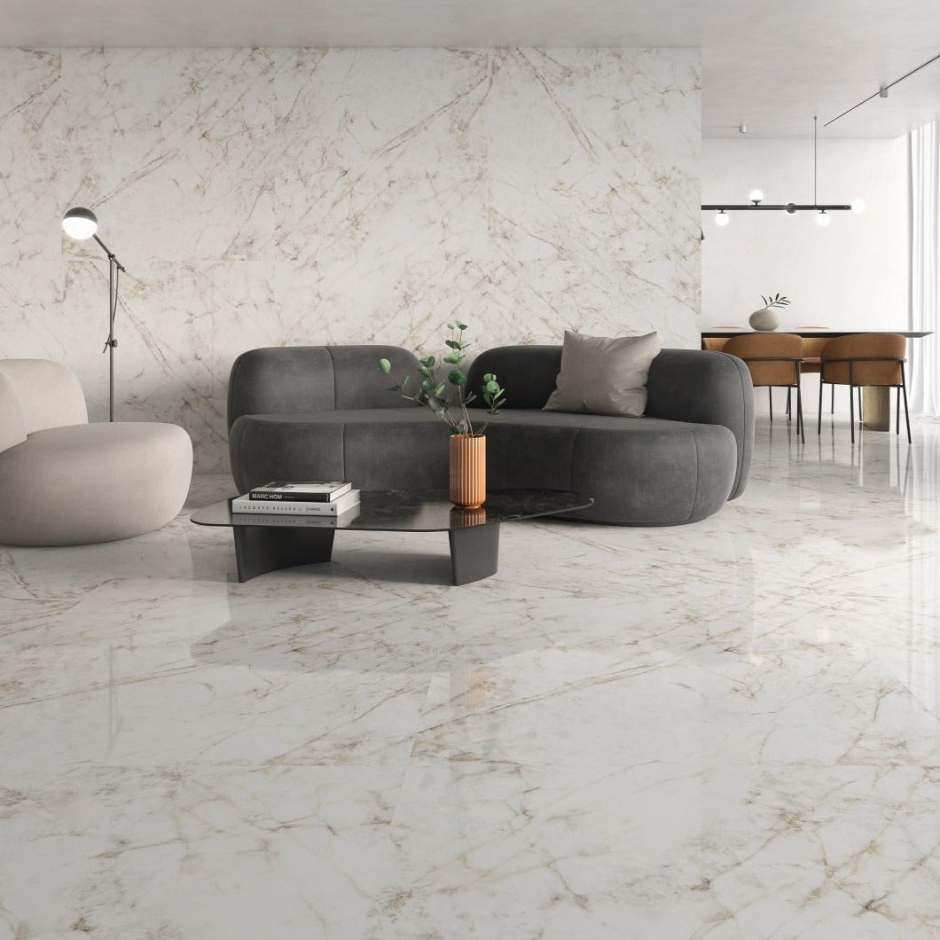 Almaden polished porcelain tile with a gold marble design for floors and walls. Made in Spain, installed in a room.