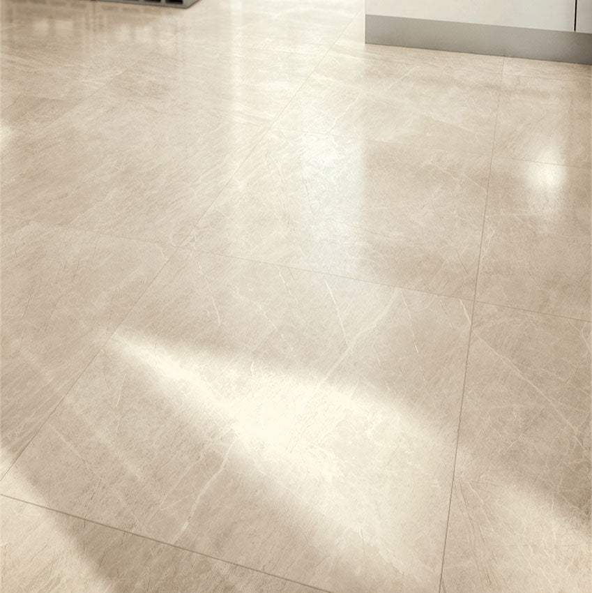 Athena Almond matte porcelain tile with a beige stone design, for floors and walls. Made in Italy, installed in a room.