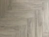 Bark Grigio matte porcelain tile with a grey wood design, for floors and walls. Made in Italy, installed in a room.