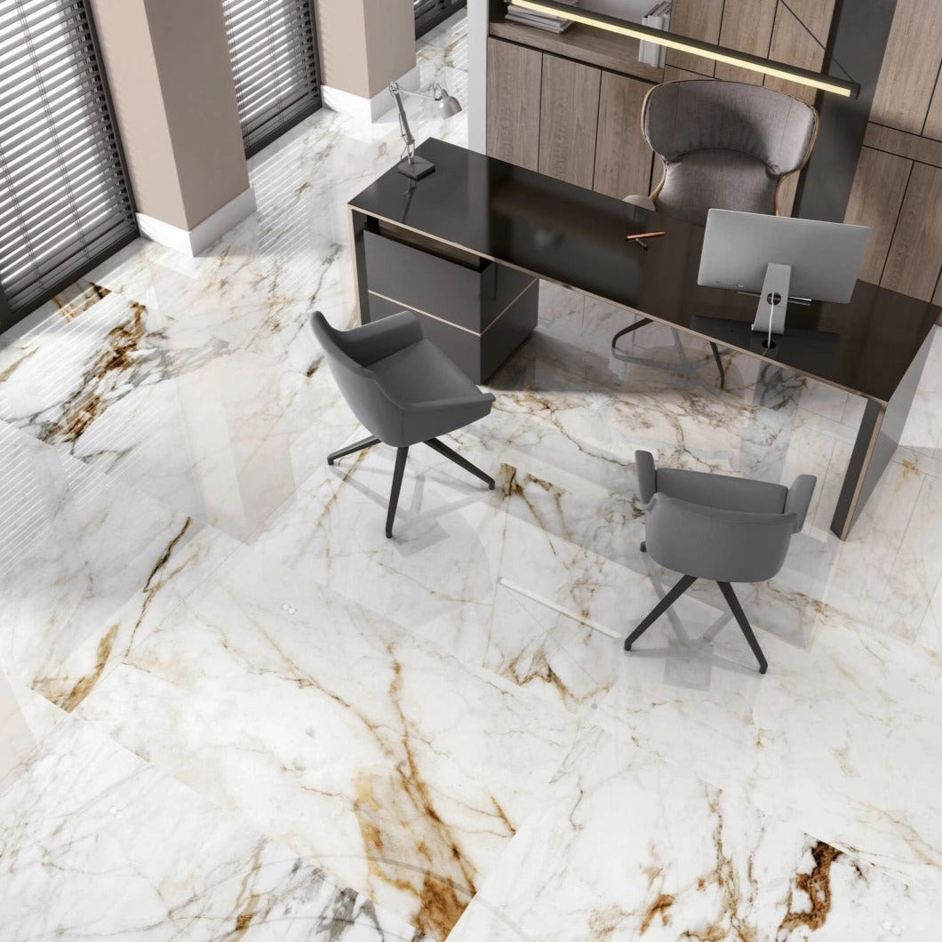 Barnaby porcelain tile with a white, gold, and silver marble design, for floors and walls. Installed in a room.