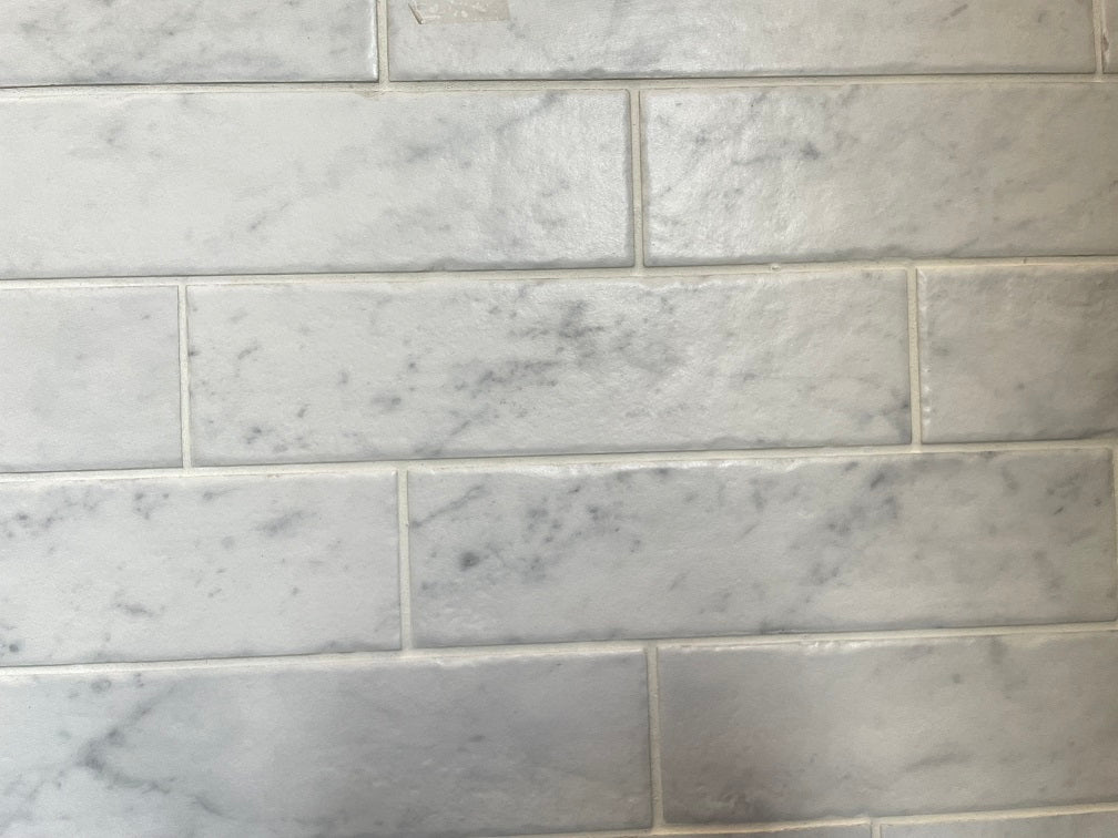 Bistrot matte porcelain tile with a white marble design, for floors and walls. Made in Italy, in a 3x11" brick size.