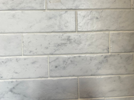 Bistrot matte porcelain tile with a white marble design, for floors and walls. Made in Italy, in a 3x11" brick size.