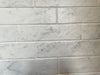 Bistrot matte porcelain tile with a white marble design, for floors and walls. Made in Italy, in a 3x11" brick size.