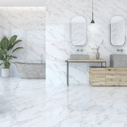 Calacatta Gold porcelain tile with a white marble design, for floors and walls. Made in Spain, installed in a room.