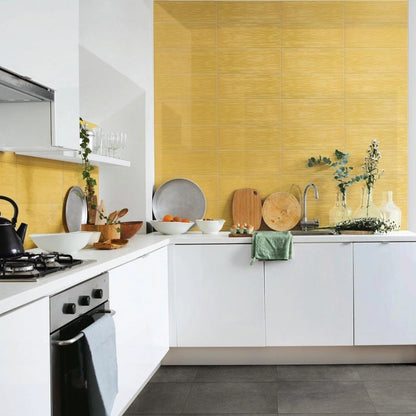 Candy Mostarda glossy ceramic tile with a yellow design, for walls. Made in Italy, installed on a backsplash.