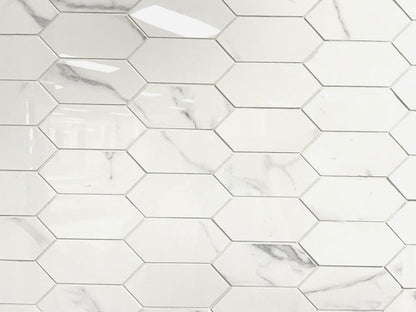 Carrara Royale polished porcelain tile in a white marble style, for floors and walls. In an elongated hexagon mosaic.