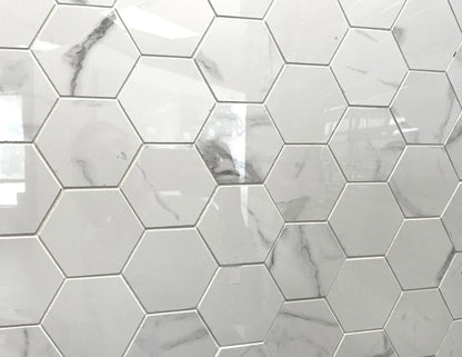 Carrara Royale polished porcelain tile in a white marble style, for floors and walls. In a large hexagon mosaic.