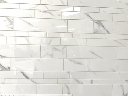 Carrara Royale polished porcelain tile in a white marble style. In a random strip mosaic size.