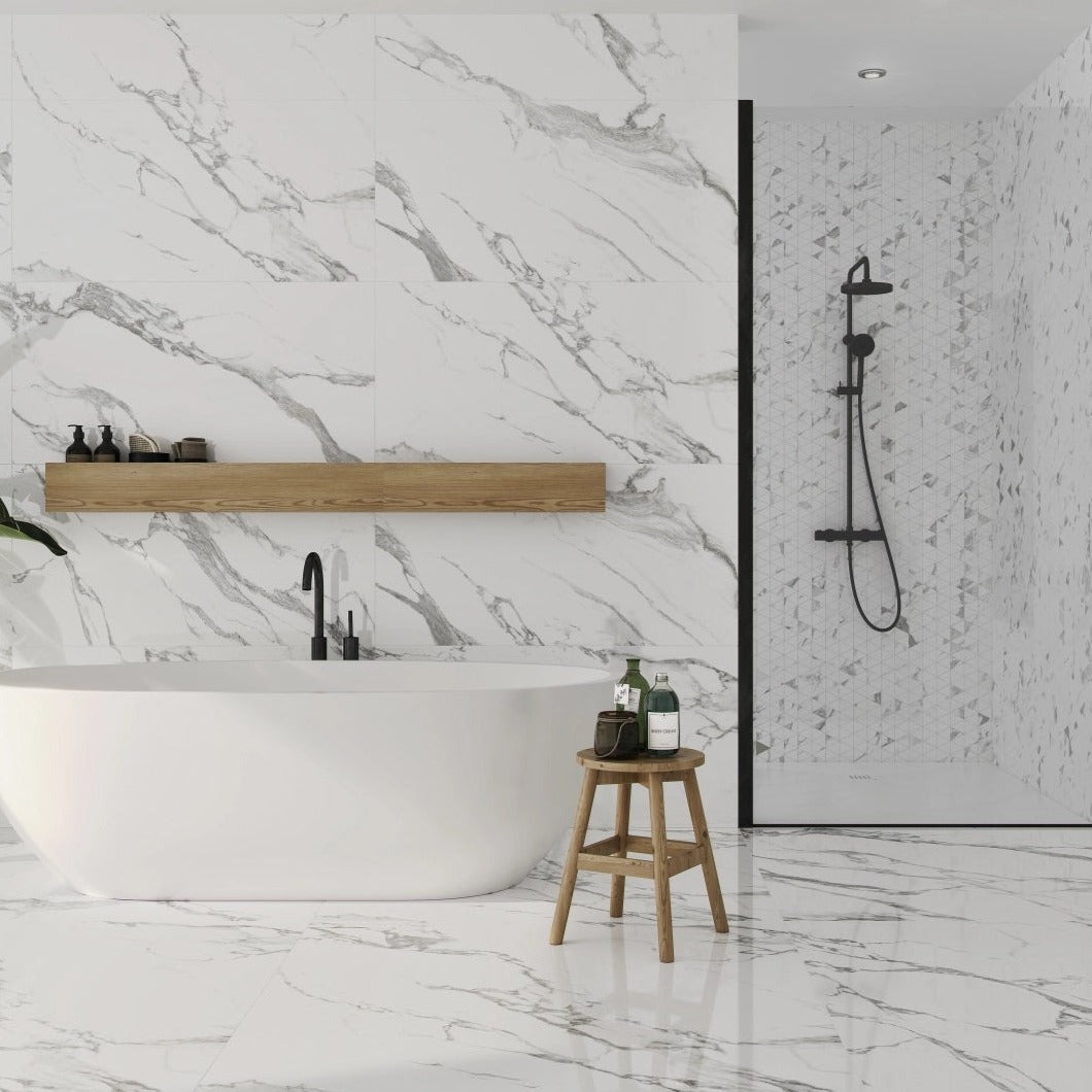Carrara White polished porcelain tile with marble design, for floors and walls. Made in Spain, installed in a bathroom.