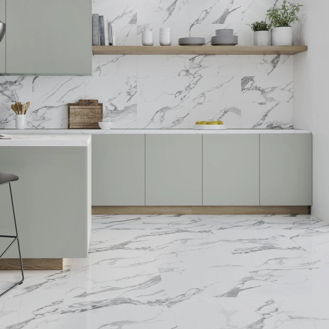 Carrara White polished porcelain tile with a marble design, for floors and walls. Made in Spain, installed in a room.