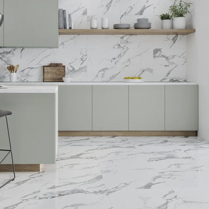 Carrara White polished porcelain tile with a marble design, for floors and walls. Made in Spain, installed in a room.