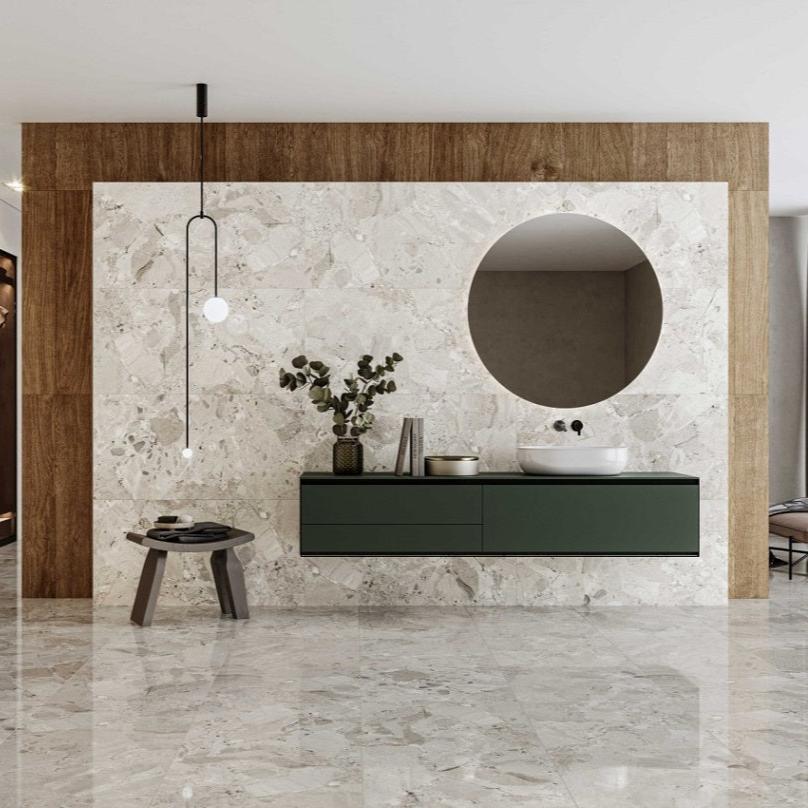 Ceppo Beige polished porcelain tile with a rock/pebble design, for floors and walls. Made in Spain, installed in a room.