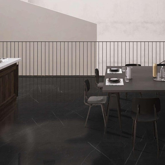 Columbia Antracite glossy porcelain tile with a stone design, for floors and walls. Made in Spain, installed in a room.