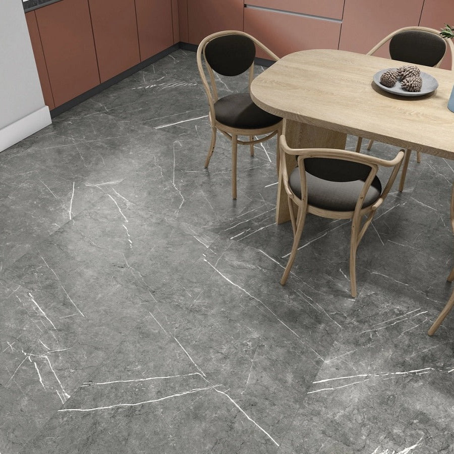 Columbia Gris porcelain tile with a grey stone design, for floors and walls. Made in Spain, installed in a room.