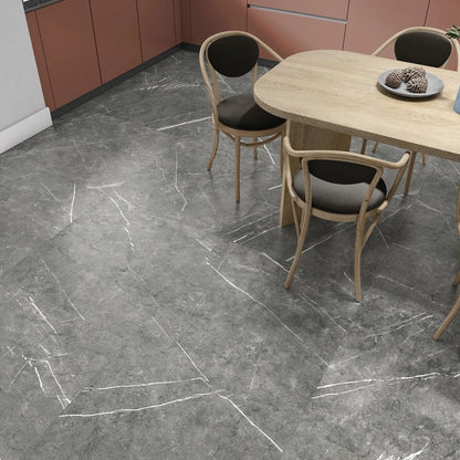 Columbia Gris porcelain tile with a grey stone design, for floors and walls. Made in Spain, installed in a room.