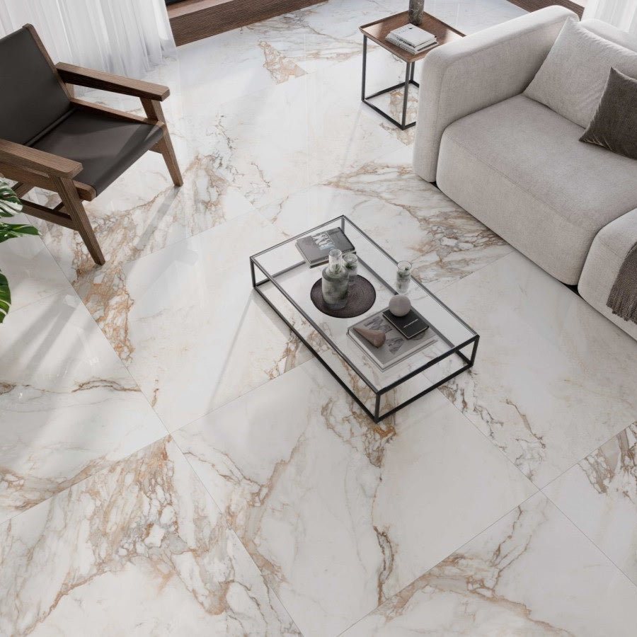 Calacatta Gold porcelain tile with a white and gold marble design, for floors and walls. Installed on the floor.