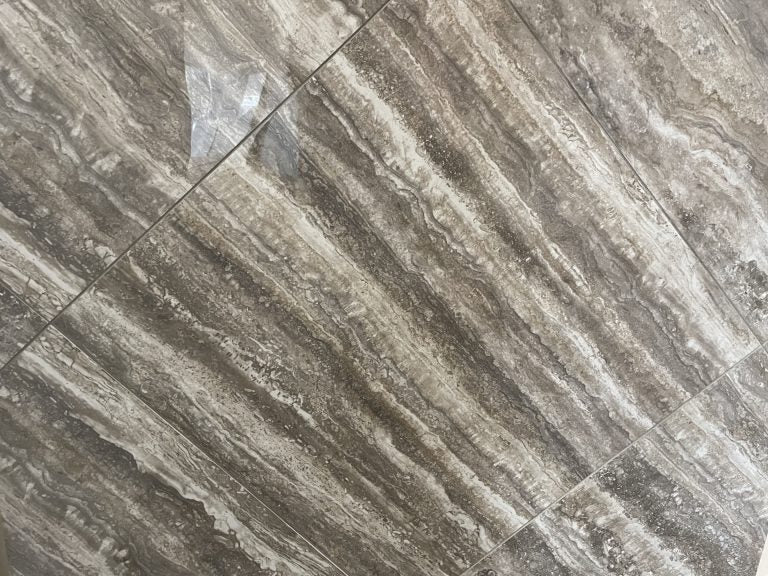 Ferrara Noce polished porcelain tile with a brown stone design, for floors and walls. In a 24x24" size.
