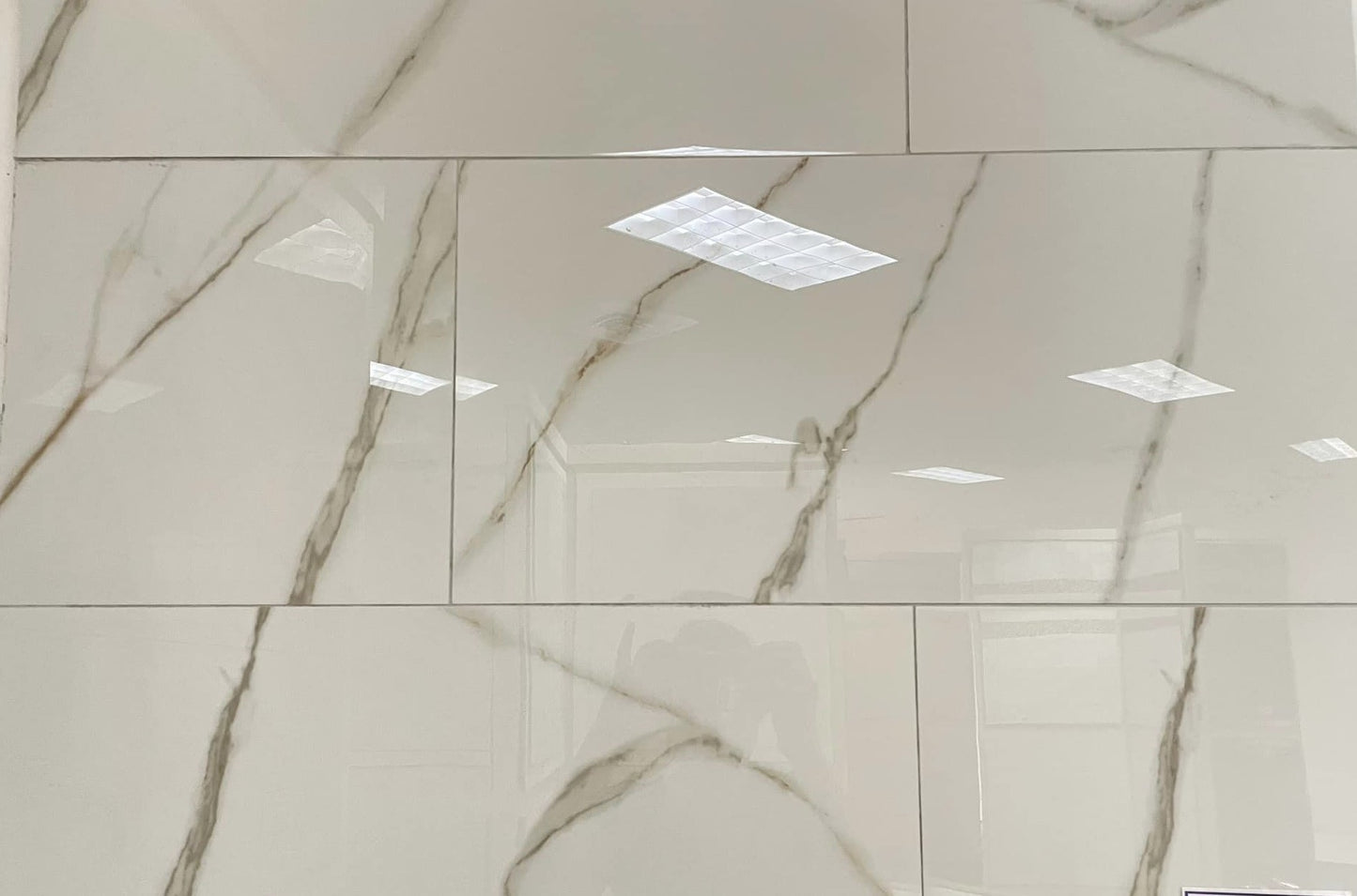 Golden Gioia polished porcelain tile with a white marble design, for floors and walls. In a 12x24" size.