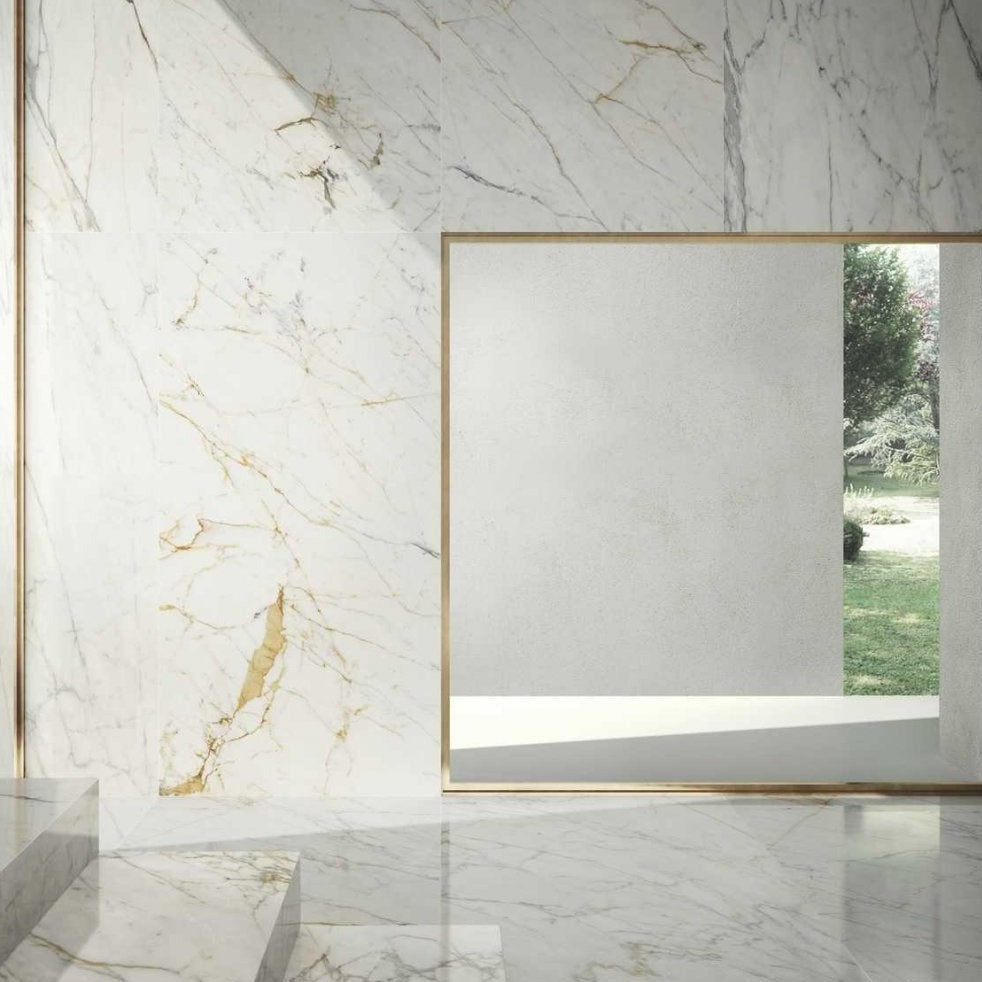 Golden White polished porcelain tile with a white marble design, for floors and walls. Made in Italy, installed in a room.