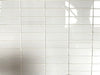 Imperial White polished porcelain tile with a pure white design, for floors and walls. In a 1x3" mosaic size.