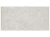 Industria Zinc matte porcelain tile with an off-white cement stone style. In a 12x24" size.