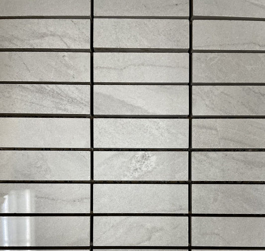 Lazio Mist polished porcelain tile with a grey stone design, for floors and walls. In a 1x3" mosaic size.