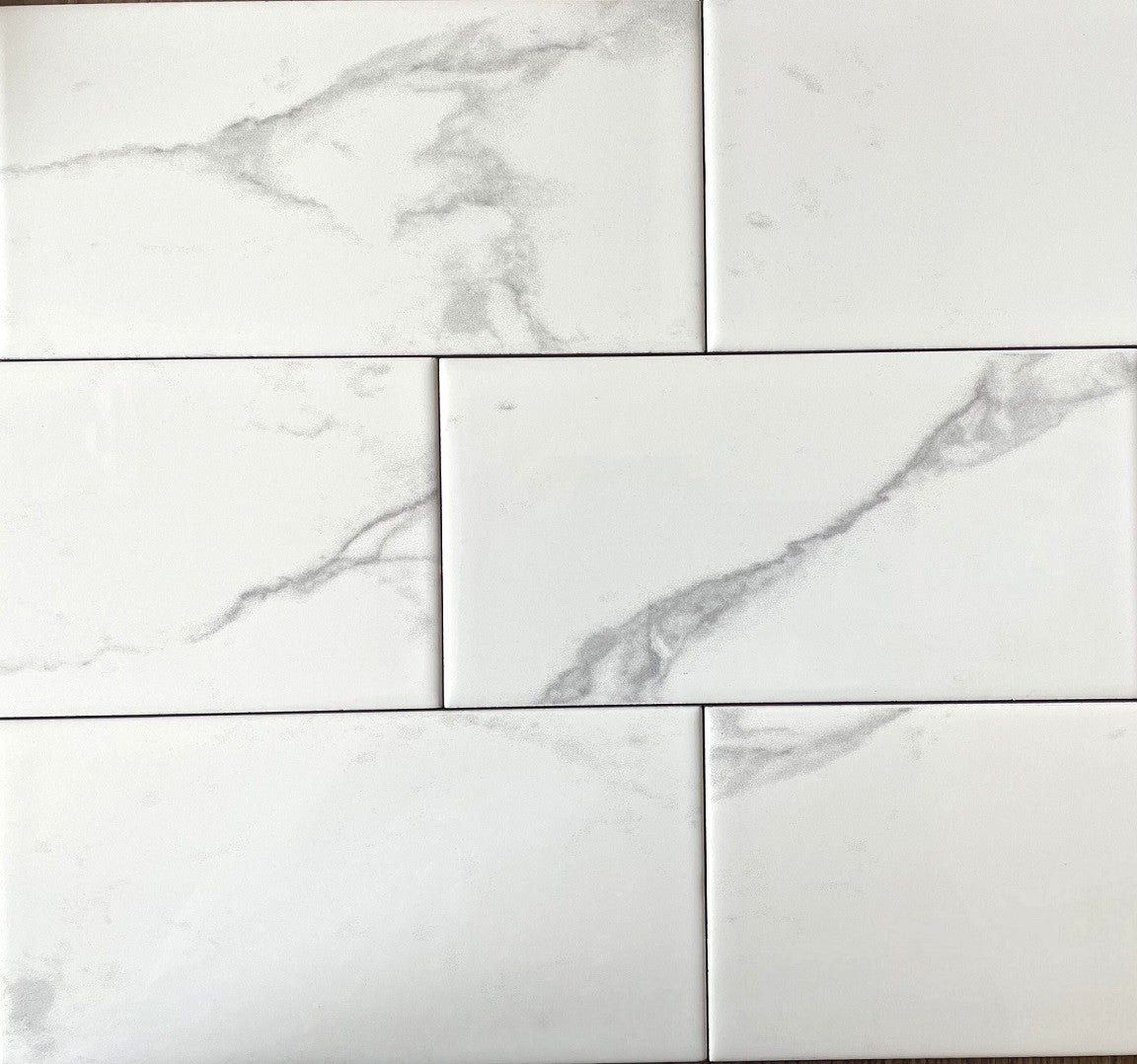 Carrara white marble style glossy ceramic subway tile, for walls. Made in Spain, in a 4x8" size.