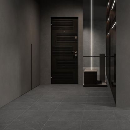 Lithos Stone Charcoal matte porcelain tile with a black stone design, for floors and walls. Installed in a room.